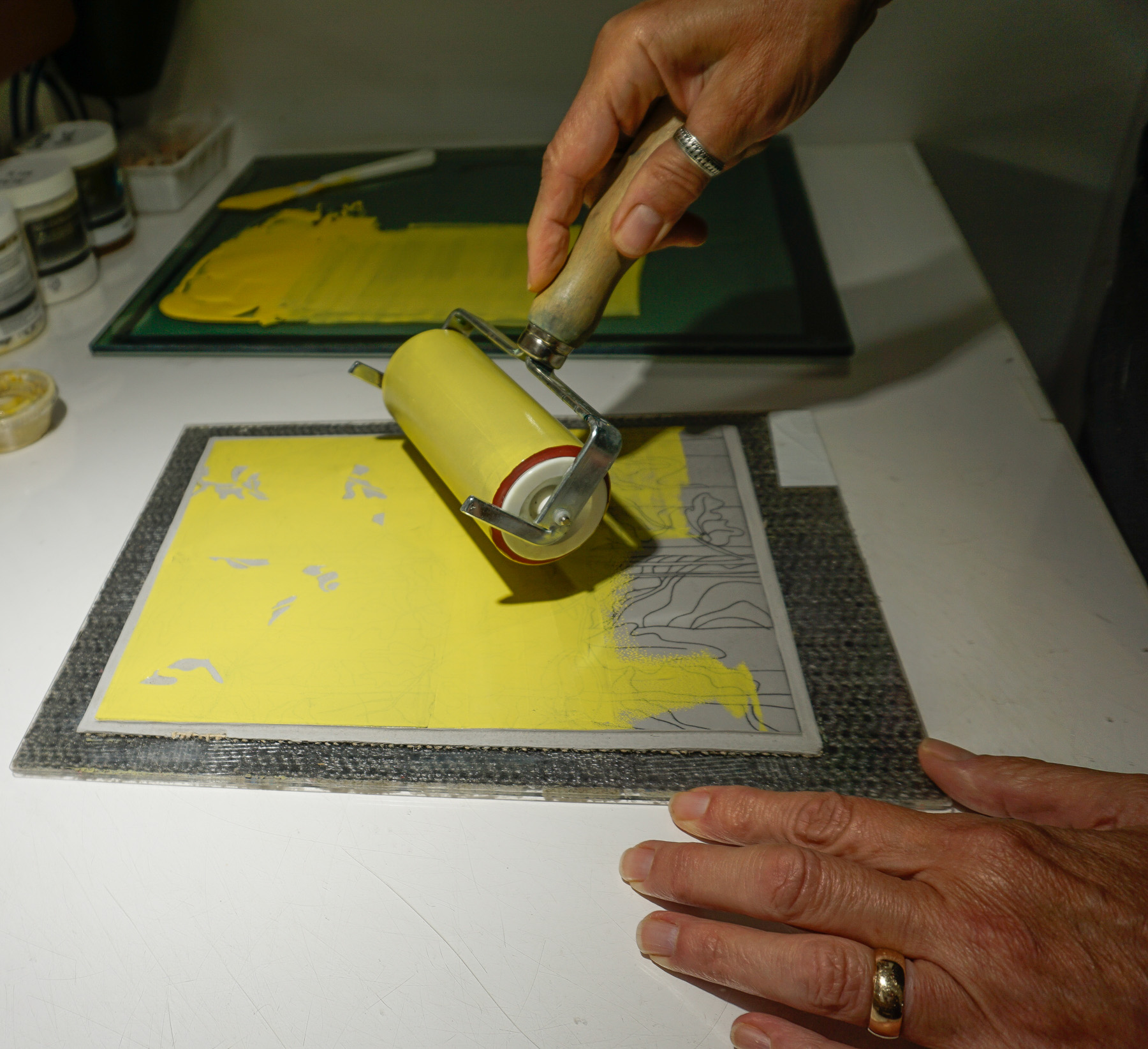 Rolling ink onto the linoleum block