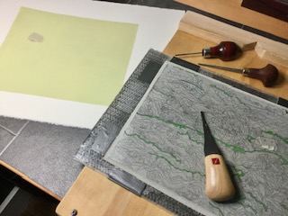 A reduction print being carved from a single block of linoleum